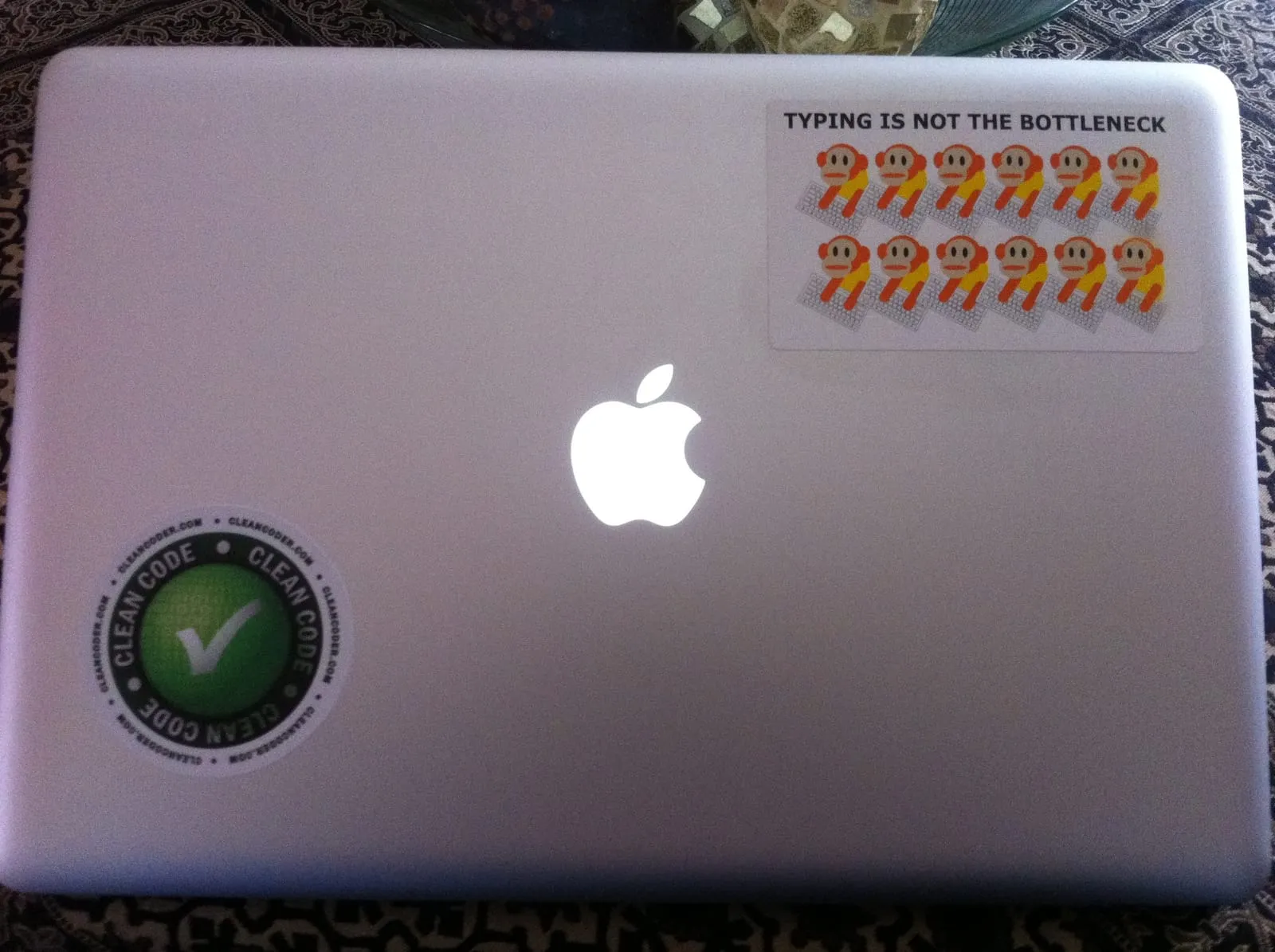 Typing is not the bottleneck sticker on a MacBook